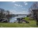 Lakeside property with a private dock, fire pit area, and lush green space at 9398 W Mirror Rd, Columbus, IN 47201