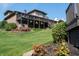 Lush backyard featuring a large deck, hot tub, and manicured landscaping, perfect for outdoor enjoyment at 9398 W Mirror Rd, Columbus, IN 47201