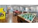 Basement rec room features an arcade machine, billiard table, foosball, and ping pong setup at 9398 W Mirror Rd, Columbus, IN 47201