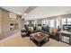 Basement sitting area with brick fireplace and views to the kitchen, dining, and patio area at 9398 W Mirror Rd, Columbus, IN 47201