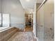 Bright bathroom featuring a jacuzzi style tub, glass enclosed shower and access to a closet at 9398 W Mirror Rd, Columbus, IN 47201