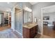 Functional bathroom featuring a vanity with sink, shower and access to a closet and adjacent room at 9398 W Mirror Rd, Columbus, IN 47201