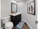 Powder room with modern vanity, marble countertop, stylish mirror and unique artwork at 9398 W Mirror Rd, Columbus, IN 47201