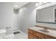Neutral-toned bathroom featuring a glass shower stall and single sink vanity with decorative trimmed mirror at 9398 W Mirror Rd, Columbus, IN 47201