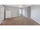Spacious empty bedroom with carpet, neutral paint and bright window at 9398 W Mirror Rd, Columbus, IN 47201