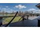 Lakefront deck with a hammock overlooking the water and green lawn at 9398 W Mirror Rd, Columbus, IN 47201
