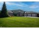 Spacious brick home with a three-car garage, lush green lawn, and basketball hoop in a suburban setting at 9398 W Mirror Rd, Columbus, IN 47201