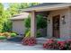 Charming front door with brick columns and colorful roses, framed by manicured landscaping at 9398 W Mirror Rd, Columbus, IN 47201