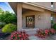 Welcoming front entrance with a wooden door, brick accents, and vibrant rose bushes at 9398 W Mirror Rd, Columbus, IN 47201