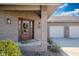 Charming front entrance with a beautiful wood door, brick accents, and well-kept landscaping at 9398 W Mirror Rd, Columbus, IN 47201