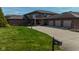 Beautiful brick home with a well-manicured lawn and three-car garage at 9398 W Mirror Rd, Columbus, IN 47201