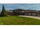 Beautiful brick home with a well-manicured lawn and three-car garage at 9398 W Mirror Rd, Columbus, IN 47201