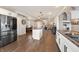 Open-concept kitchen with stainless appliances, center island, and seamless flow to dining area at 9398 W Mirror Rd, Columbus, IN 47201