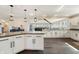 Bright kitchen showcases granite countertops, white cabinets, and an open floor plan to the living area at 9398 W Mirror Rd, Columbus, IN 47201