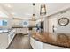Bright kitchen featuring granite countertops, stainless steel appliances, and modern lighting at 9398 W Mirror Rd, Columbus, IN 47201