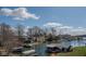 Waterfront homes and boat docks along the calm lake under a partly cloudy sky at 9398 W Mirror Rd, Columbus, IN 47201