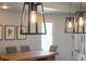 Close-up of modern pendant lighting above the dining table, highlighting stylish interior details at 9398 W Mirror Rd, Columbus, IN 47201