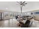 Bright living room features natural light, hardwood floors and comfortable seating with views of the outdoor deck at 9398 W Mirror Rd, Columbus, IN 47201