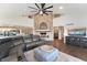 This open living area showcases a brick fireplace, a sectional sofa and views into the kitchen at 9398 W Mirror Rd, Columbus, IN 47201