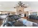 Cozy living room features a brick fireplace, ceiling fan, and a comfortable, oversized sectional sofa at 9398 W Mirror Rd, Columbus, IN 47201