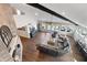 Bright and airy living room with hardwood floors, fireplace, and leather sectional at 9398 W Mirror Rd, Columbus, IN 47201