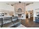 Open living area with a brick fireplace, hardwood floors, and a comfortable sectional sofa with great light at 9398 W Mirror Rd, Columbus, IN 47201