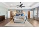 Spacious main bedroom with tray ceiling, ceiling fan, and ensuite bathroom access at 9398 W Mirror Rd, Columbus, IN 47201