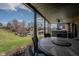 Covered patio with outdoor dining table and a view of the lake at 9398 W Mirror Rd, Columbus, IN 47201