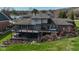 Aerial view of the backyard with a multi-level deck and well-maintained lawn at 9398 W Mirror Rd, Columbus, IN 47201