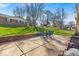 Backyard patio featuring a brick wall and outdoor seating area on the green lawn at 9715 Mallery Dr, Noblesville, IN 46060
