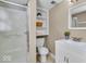 Bathroom featuring a glass door shower, white vanity and linen storage, and neutral walls at 9715 Mallery Dr, Noblesville, IN 46060