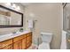 Neutral bathroom featuring a wood vanity, white countertop, decorative mirror and tiled walk-in shower at 9715 Mallery Dr, Noblesville, IN 46060