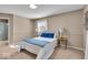 Cozy bedroom showcasing a bed with blue accents, complementing lamps, carpeted floor and natural light at 9715 Mallery Dr, Noblesville, IN 46060