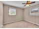 Bedroom with neutral walls, two windows providing natural light, and plush carpeting at 9715 Mallery Dr, Noblesville, IN 46060