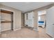 Bedroom showing a walk-in closet and a bed with blue accents, complementing lamps and carpeted floor at 9715 Mallery Dr, Noblesville, IN 46060