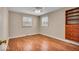 Bedroom with hardwood floors, built-in shelving, and natural light at 9715 Mallery Dr, Noblesville, IN 46060