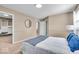 Neutral bedroom featuring a bed with blue accents, complementing lamps, carpeted floor and natural light at 9715 Mallery Dr, Noblesville, IN 46060
