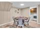 Dining area featuring a round table with chairs, carpet floors, and a laundry area in the background at 9715 Mallery Dr, Noblesville, IN 46060