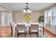 Dining room with chandelier, seating for six, and large windows at 9715 Mallery Dr, Noblesville, IN 46060