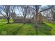 Charming single-story home with a lush front lawn shaded by mature trees, and a brick exterior at 9715 Mallery Dr, Noblesville, IN 46060
