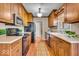 Well-lit kitchen featuring wood cabinets, modern appliances, and a window over the kitchen sink at 9715 Mallery Dr, Noblesville, IN 46060