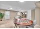 Open living space features a unique game table and a cozy seating area near the brick fireplace at 9715 Mallery Dr, Noblesville, IN 46060