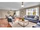 Inviting living room that flows seamlessly into the dining area, with a comfortable sofa at 9715 Mallery Dr, Noblesville, IN 46060