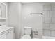 A cozy bathroom with a modern vanity, toilet, and tiled shower at 1049 N Traub Ave, Indianapolis, IN 46222