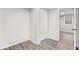 A bright bedroom with wood flooring, closet, and doorway at 1049 N Traub Ave, Indianapolis, IN 46222
