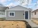 Charming home featuring modern siding, a well-manicured lawn, and a welcoming entryway at 1049 N Traub Ave, Indianapolis, IN 46222