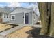 View of a home with modern gray siding and landscaping, featuring a walkway to the entrance at 1049 N Traub Ave, Indianapolis, IN 46222