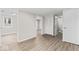 A spacious hallway with gray walls, luxury vinyl plank flooring, and updated closet at 1049 N Traub Ave, Indianapolis, IN 46222