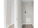 A hallway includes doors, floors, laundry access, and a neutral color scheme at 1049 N Traub Ave, Indianapolis, IN 46222