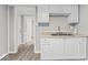 Well-organized kitchen features a stainless steel sink, white cabinetry, and updated flooring at 1049 N Traub Ave, Indianapolis, IN 46222